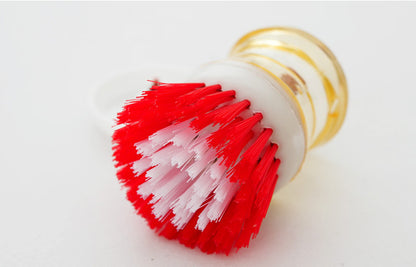 Dish brush with a detergent reservoir