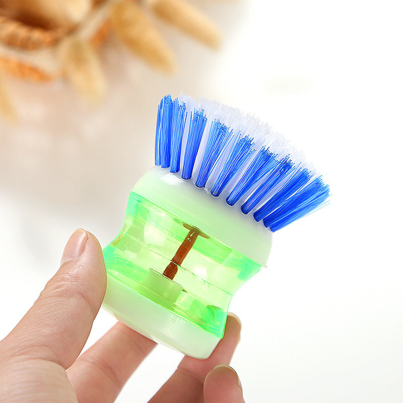 Dish brush with a detergent reservoir